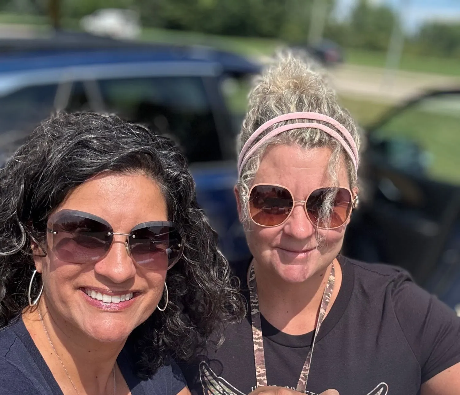 Two VFO field team members smiling outdoors during a petition drive.