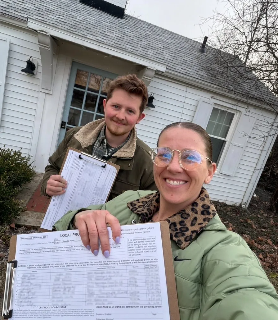 Two VFO field staff working door to door with clipboards outside a home