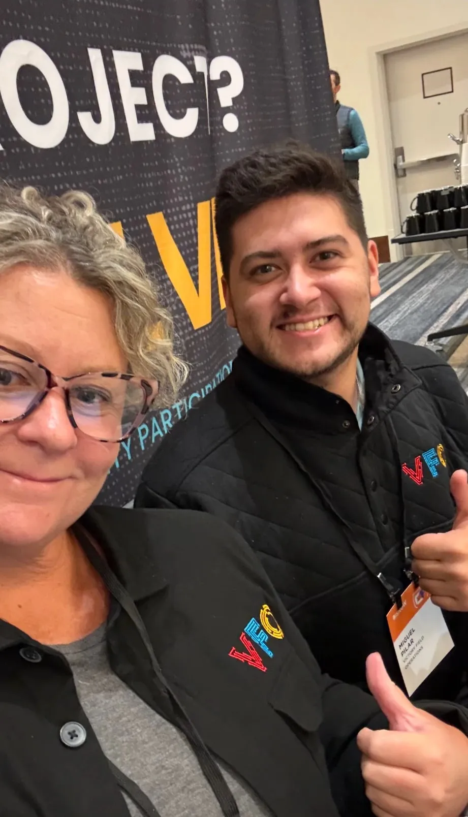 Two VFO team members at a VFO exhibit booth at an industry event.